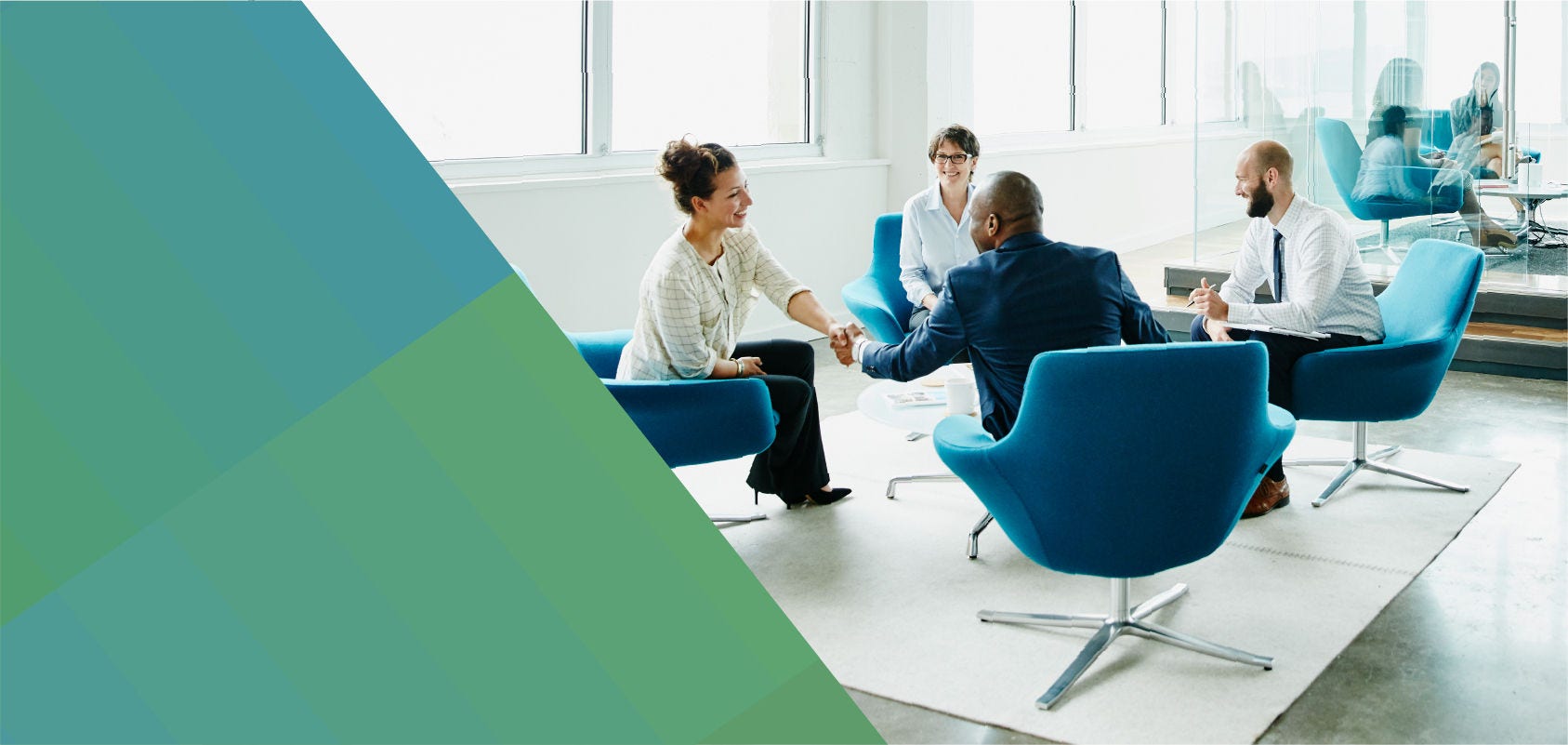 Professionals greet each other at the start of a meeting.