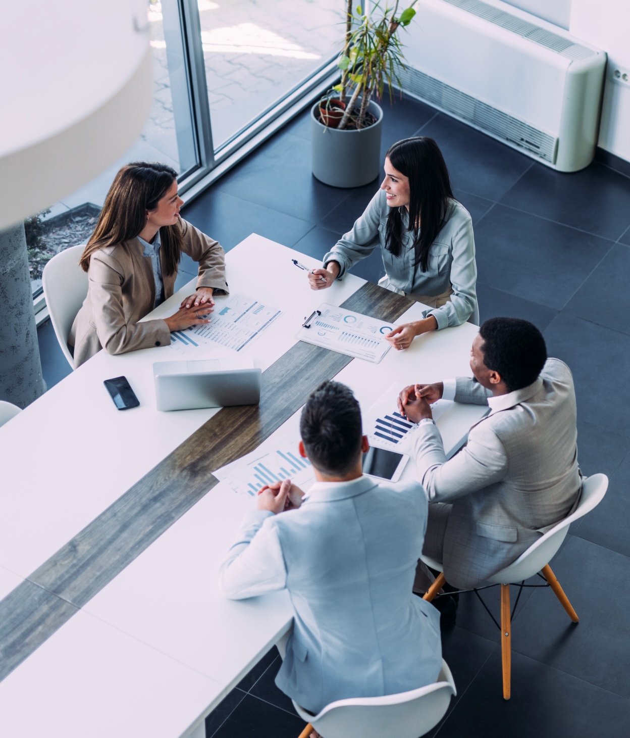 Team members holding a meeting in a modern office setting.